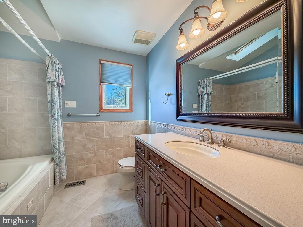 304 Barnsbury Road Langhorne, PA 19047 - Photo 37 of 55 a bathroom with a sink a large mirror and a bathtub