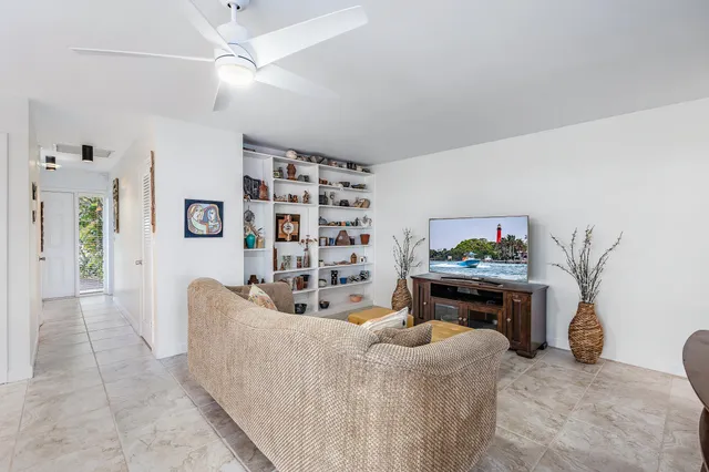 a living room with furniture and a painting on the wall