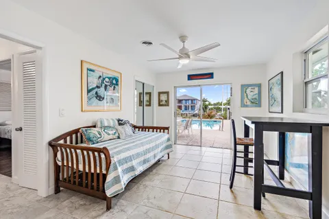 a spacious bedroom with a bed a couch and a painting on the wall