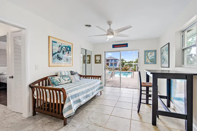 a spacious bedroom with a bed a couch and a painting on the wall