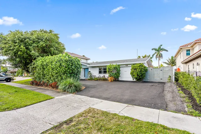 a front view of a house with a yard and a garage
