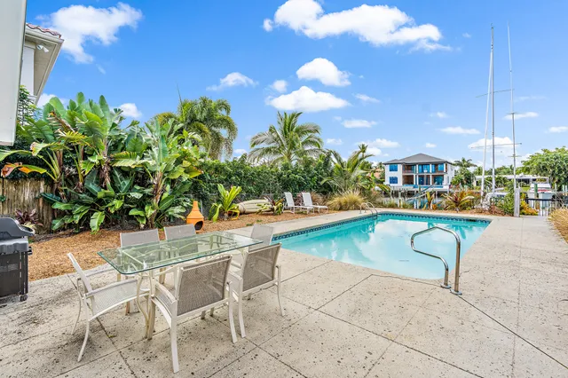 a view of a swimming pool with outdoor seating