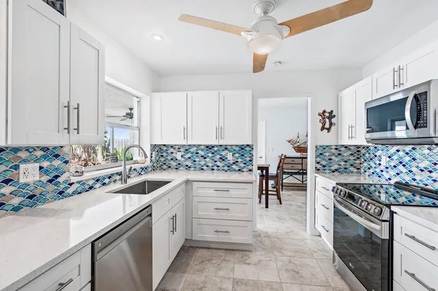 a kitchen with granite countertop cabinets and appliances
