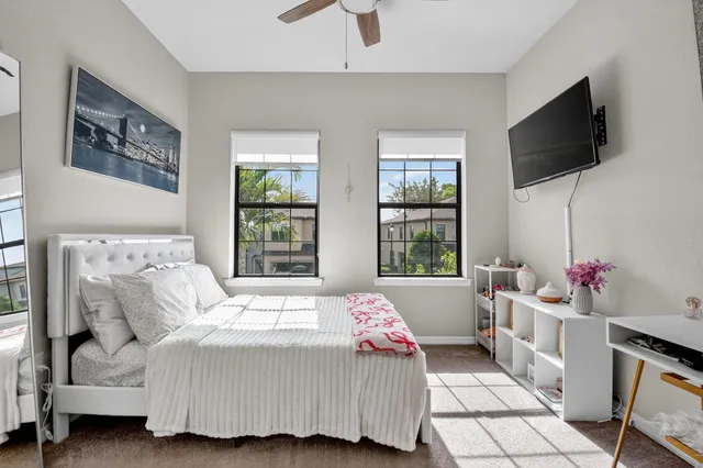 a bedroom with a bed and a desk