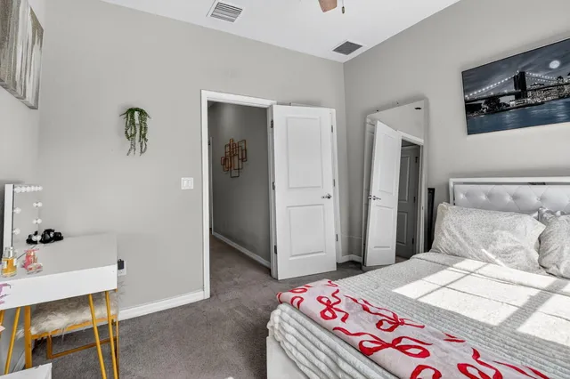 a bedroom with a bed and a television