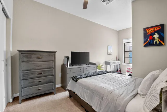 a bedroom with bed and a window