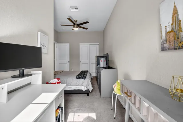 a bedroom with a bed and a flat screen tv