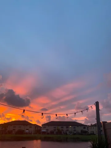 a view of a patio with lawn chairs under an umbrella