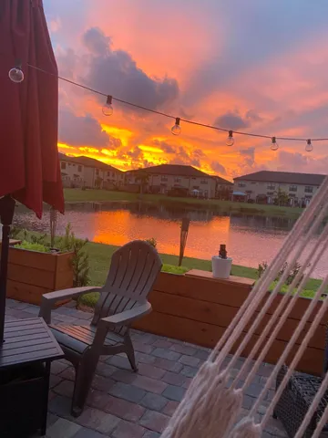 a front view of a house with a garden and plants