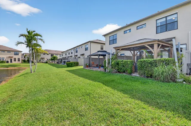 a view of a house with swimming pool and sitting area