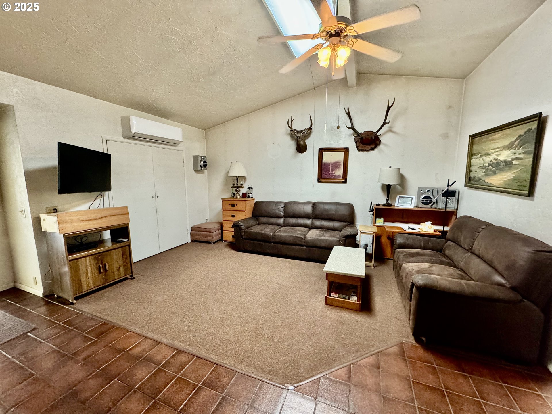4990 Mitchell Loop Road Florence, OR 97439 - Photo 5 of 37 a living room with furniture and a flat screen tv