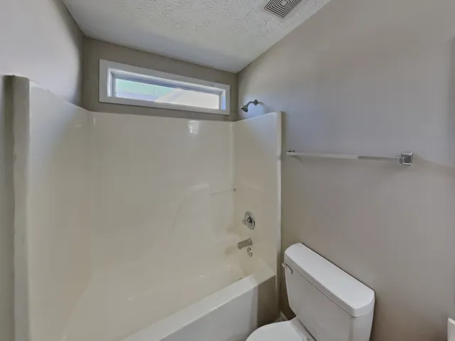 a bathroom with a toilet and a bathtub