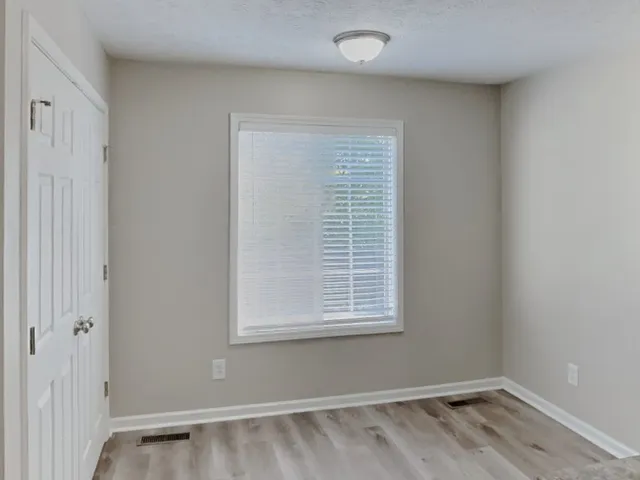 a view of a room with wooden floor and windows