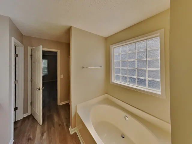 a bathroom with a tub and sink