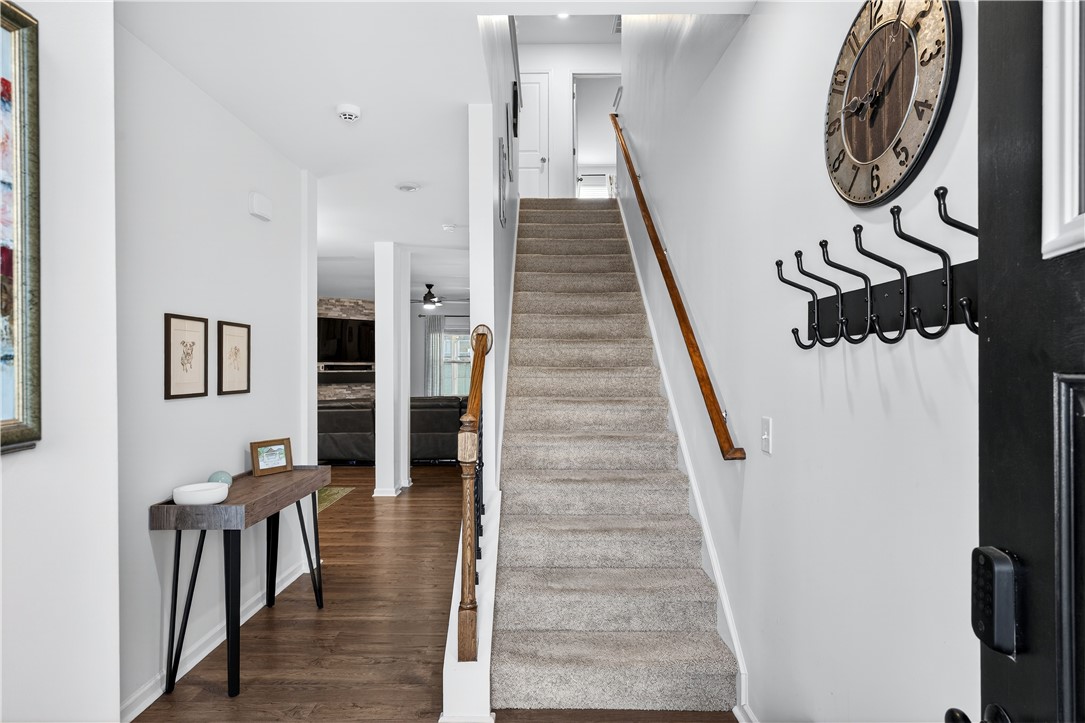 102 Preservation Drive Greer, SC 29650 - Photo 11 of 44 This welcoming entryway showcases a grand staircase and gleaming hardwood floors, creating an inviting first impression.
