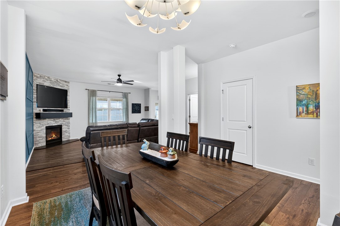 102 Preservation Drive Greer, SC 29650 - Photo 15 of 44 This inviting dining area seamlessly connects to a living space featuring a cozy fireplace.
