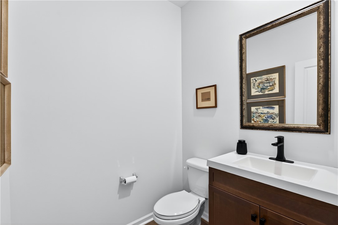 102 Preservation Drive Greer, SC 29650 - Photo 16 of 44 This sleek bathroom features a modern vanity and a classic mirror, creating a refined space.