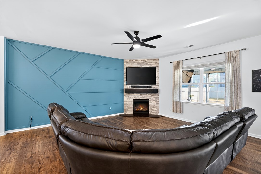102 Preservation Drive Greer, SC 29650 - Photo 17 of 44 This inviting living space features an electric fireplace and durable hardwood flooring.
