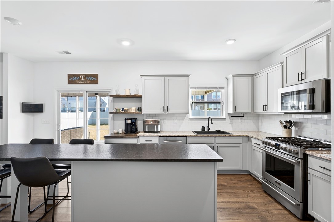 102 Preservation Drive Greer, SC 29650 - Photo 19 of 44 This kitchen features a central island, ample cabinet space, and sleek stainless steel appliances.