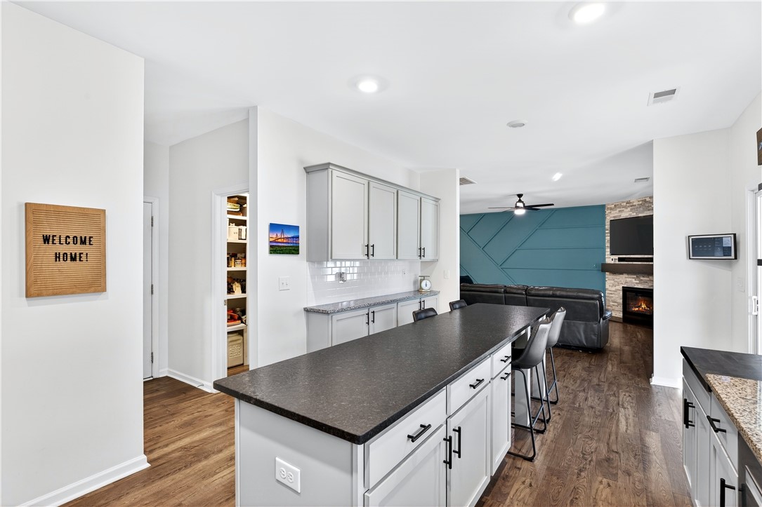 102 Preservation Drive Greer, SC 29650 - Photo 20 of 44 This open concept kitchen flows seamlessly into a cozy living space with a warm fireplace.