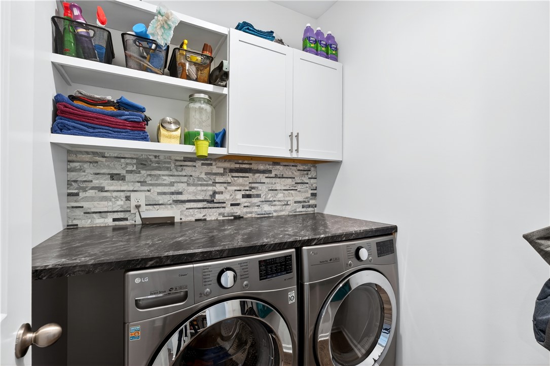 102 Preservation Drive Greer, SC 29650 - Photo 22 of 44 This functional laundry area features modern appliances and ample storage.