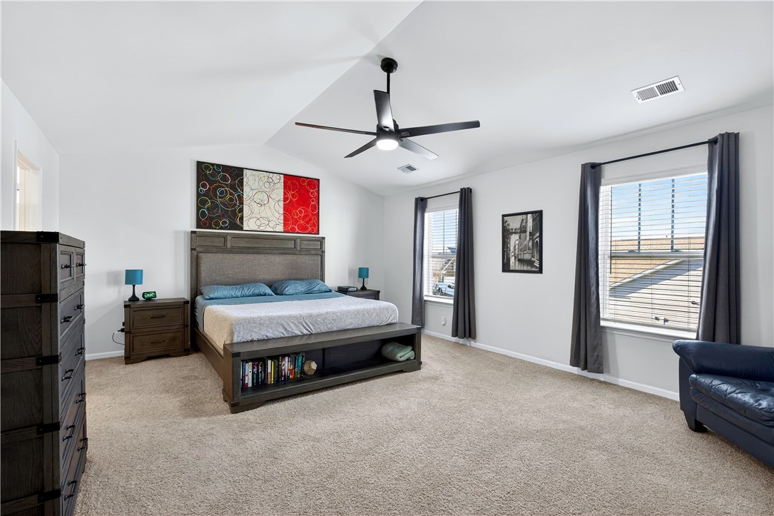 102 Preservation Drive Greer, SC 29650 - Photo 24 of 44 This spacious bedroom features a vaulted ceiling and ample natural light, perfect for comfortable living.