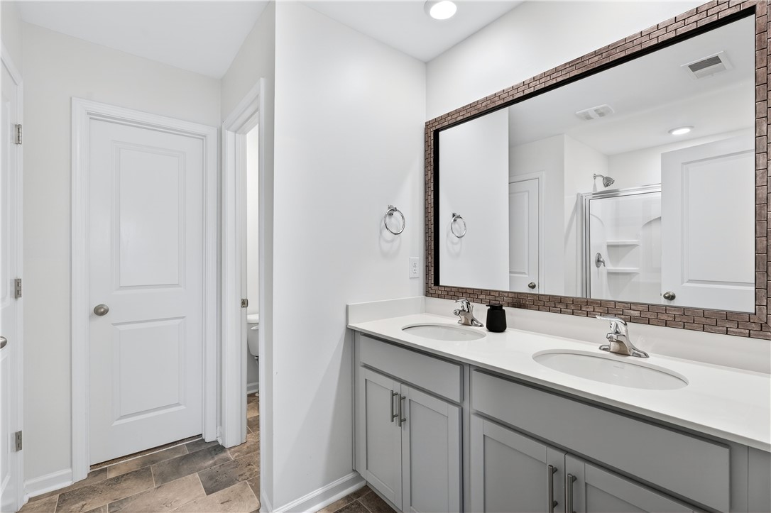 102 Preservation Drive Greer, SC 29650 - Photo 26 of 44 This bright bathroom features a spacious double vanity, offering both style and functionality.