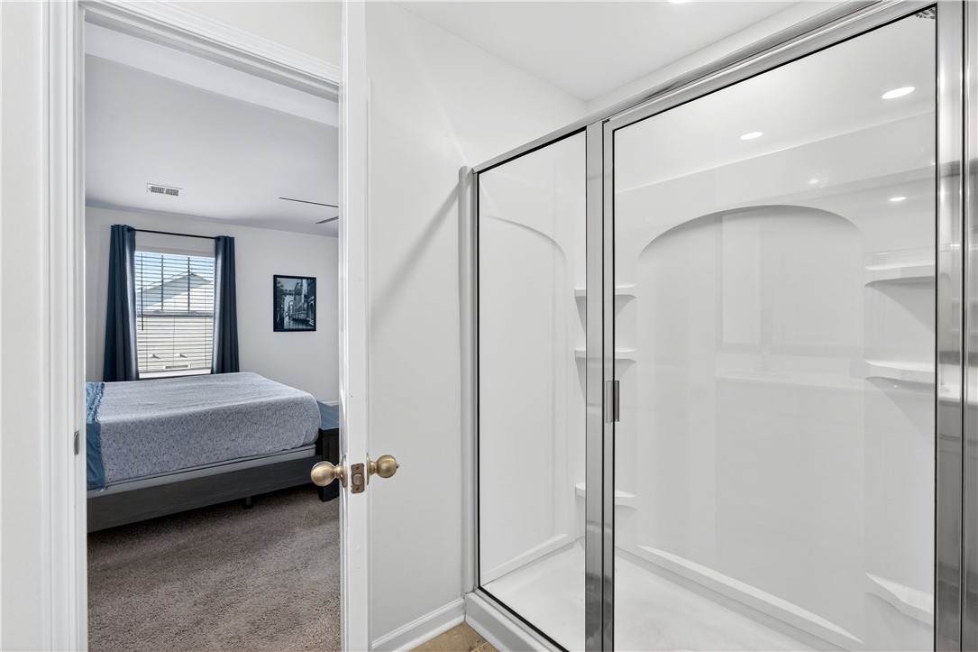 102 Preservation Drive Greer, SC 29650 - Photo 28 of 44 This bright bathroom features a spacious shower with a glass enclosure, offering a clean and modern design.