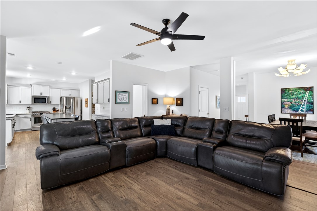 102 Preservation Drive Greer, SC 29650 - Photo 3 of 44 This inviting space seamlessly connects the kitchen, living area, and dining, offering both comfort and modern convenience.