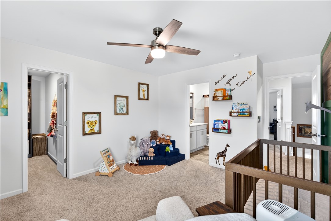 102 Preservation Drive Greer, SC 29650 - Photo 36 of 44 This cozy bedroom features a ceiling fan, plush carpeting, and an adjacent bathroom.