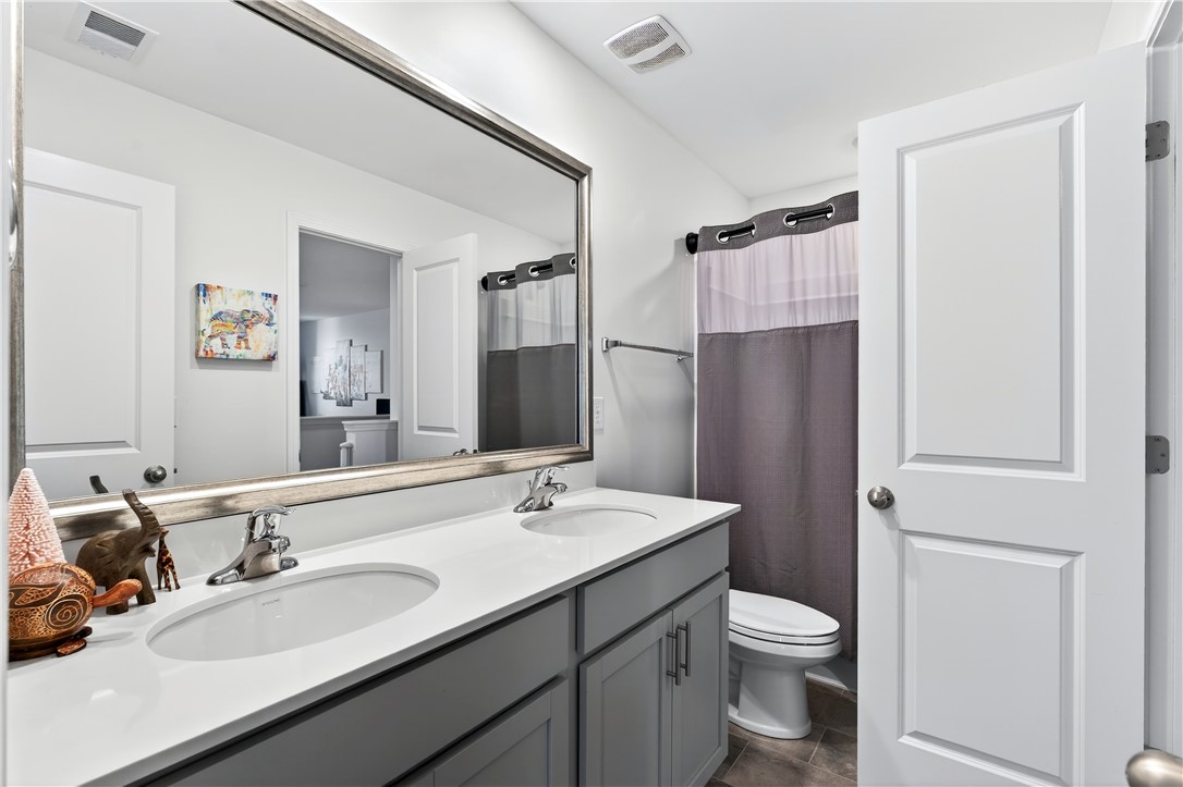 102 Preservation Drive Greer, SC 29650 - Photo 37 of 44 This bathroom features a double vanity and sleek fixtures.