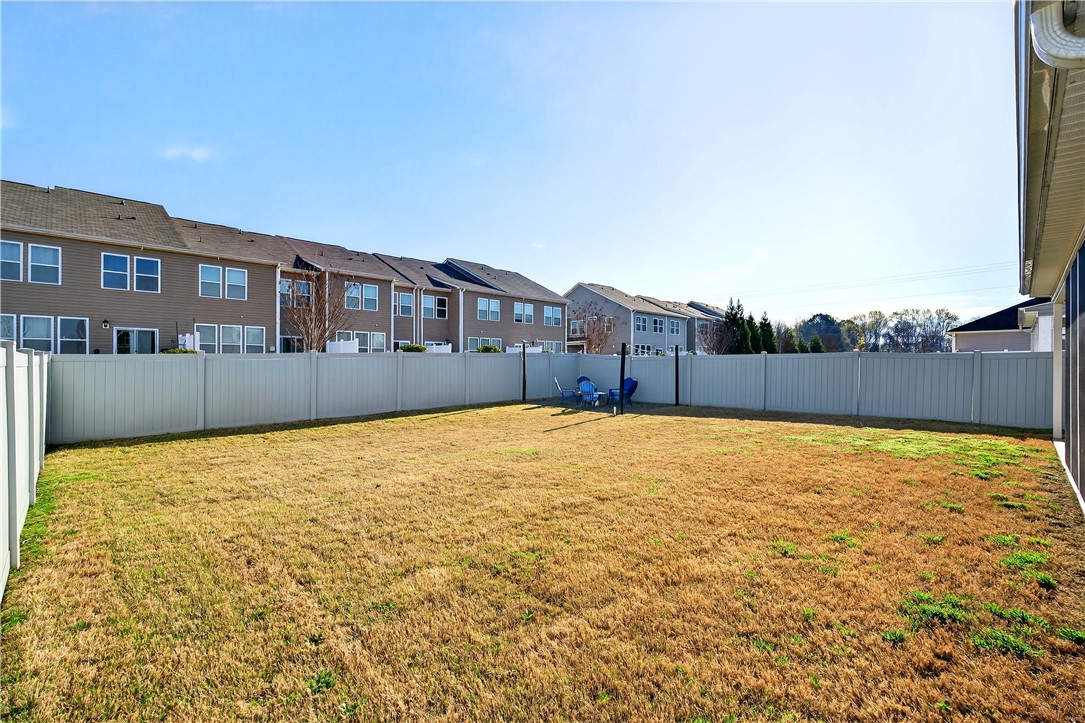 102 Preservation Drive Greer, SC 29650 - Photo 39 of 44 This spacious backyard features a durable privacy fence, ideal for outdoor enjoyment and gatherings.