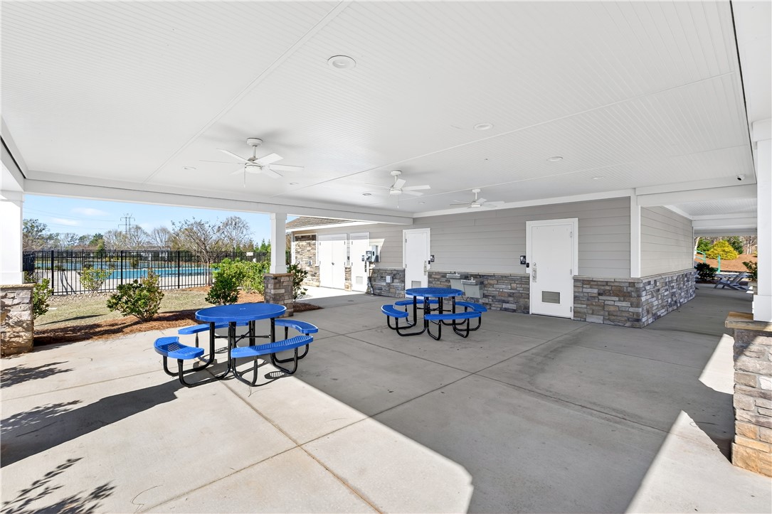 102 Preservation Drive Greer, SC 29650 - Photo 42 of 44 This inviting covered patio features ample seating, ideal for community gatherings and outdoor leisure.