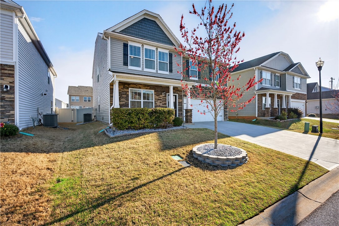 102 Preservation Drive Greer, SC 29650 - Photo 7 of 44 This charming residence features a classic facade and a meticulously maintained front yard.
