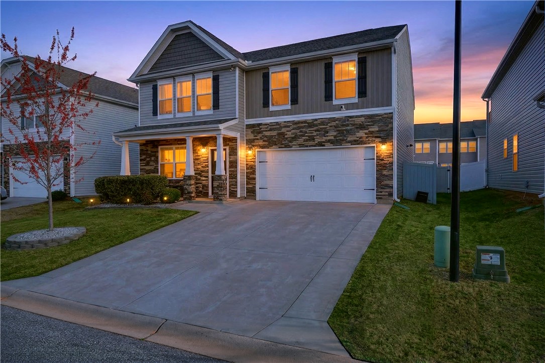 102 Preservation Drive Greer, SC 29650 - Photo 8 of 44 This inviting residence features a well-maintained exterior and an attached garage, perfect for modern living.