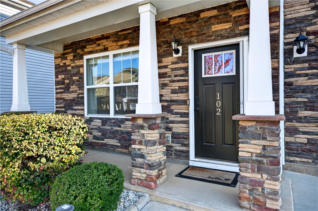 102 Preservation Drive Greer, SC 29650 - Photo 10 of 44 This charming home showcases a welcoming entrance with stacked stone accents and a covered porch.