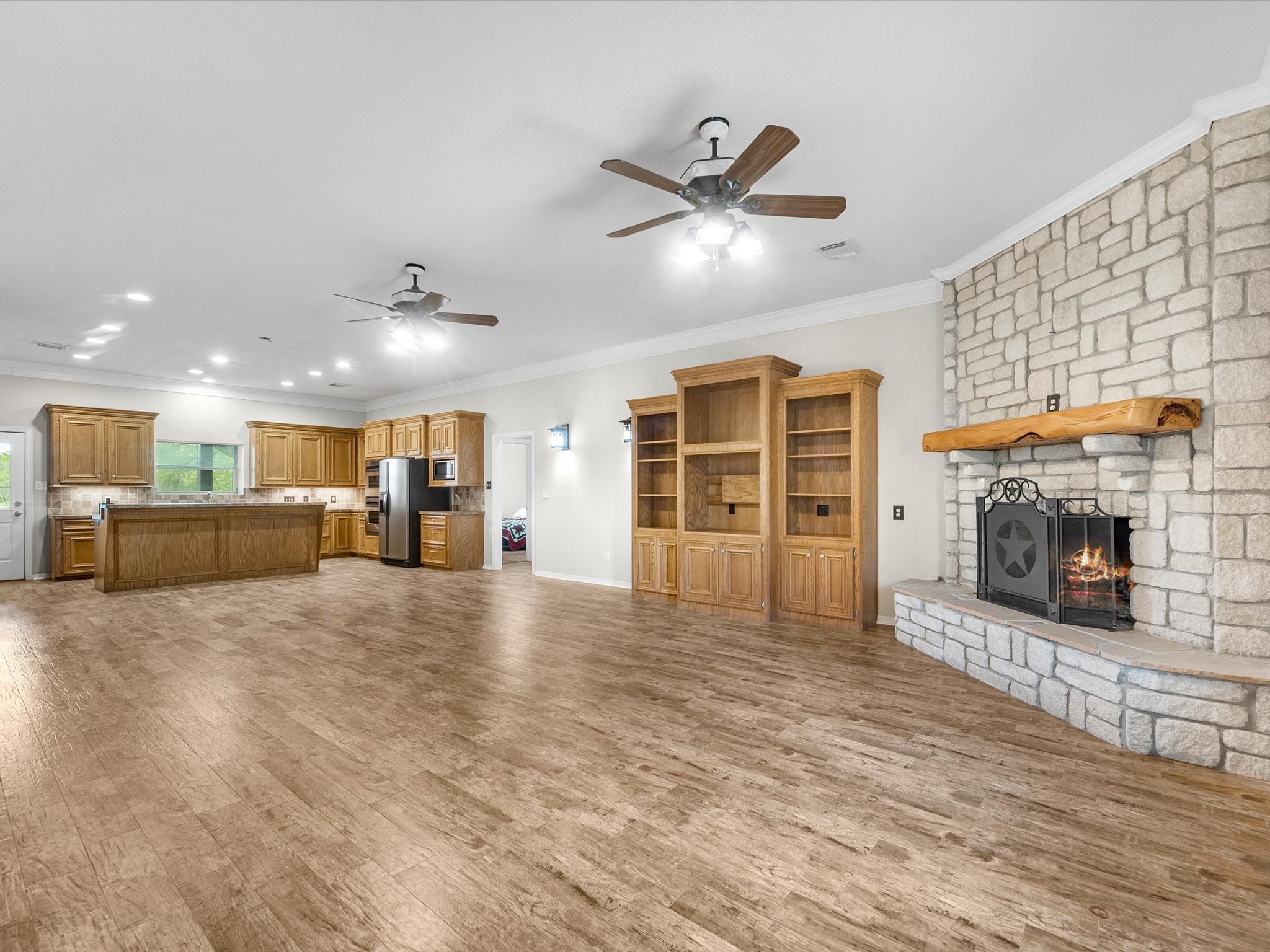 2600 Euell Road Crosby, TX 77532 - Photo 13 of 42 Expansive, open concept living with a wood burning, stone hearth anchoring the space.