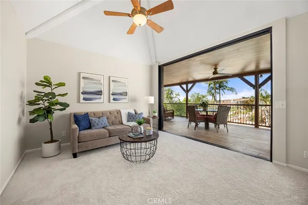 a dining room with furniture a chandelier and wooden floor