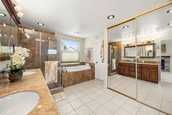 a bathroom with a granite countertop sink a toilet and shower