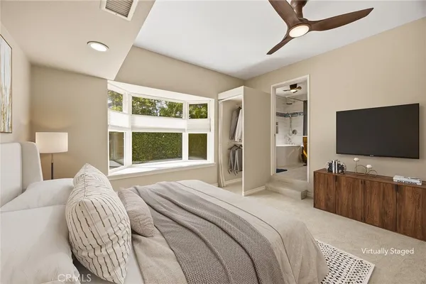 a bedroom with bed and a chandelier