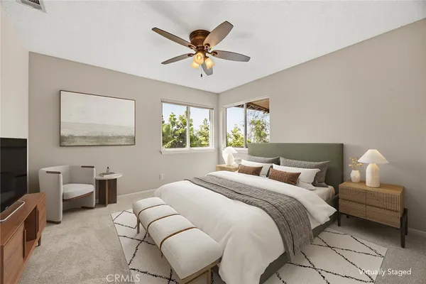 a view of a backyard with lawn chairs potted plants and palm tree