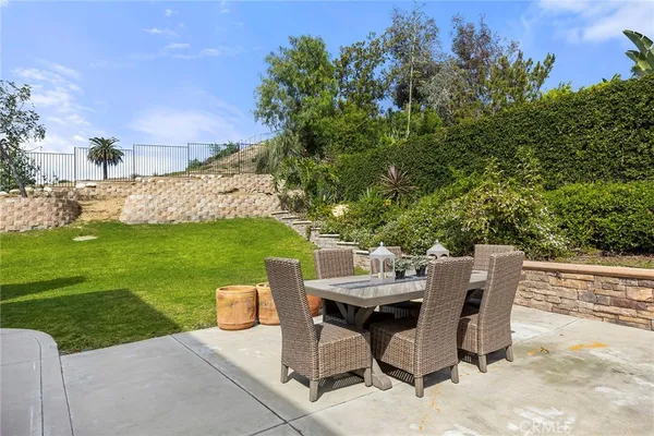 a view of a patio with table and chairs and potted plants