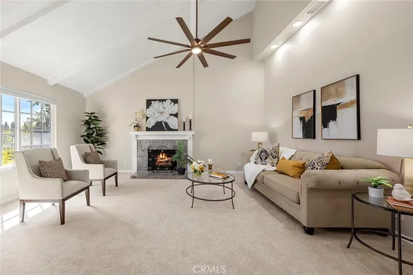 a living room with furniture and a fireplace