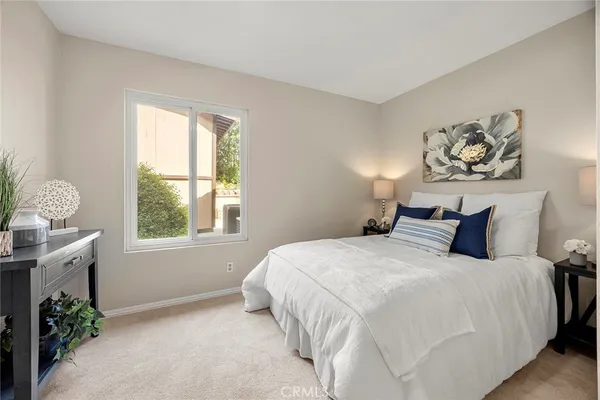 a bedroom with a bed and a window