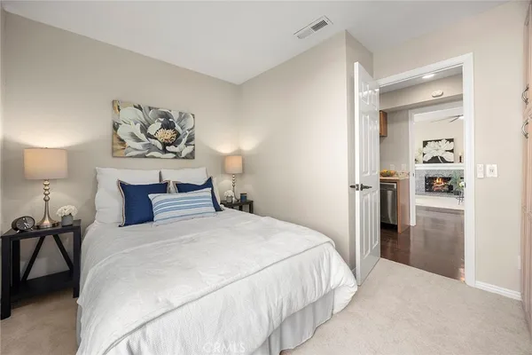 a bedroom with a bed and painting on the wall