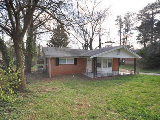 3437 Longleaf Drive Decatur, GA 30032 - Photo 1 of 1 a front view of a house with a garden and trees
