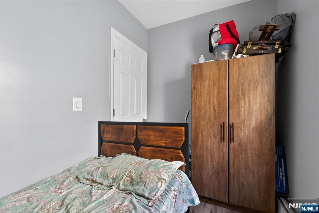229 Patterson Street Harrison, NJ 07029 - Photo 12 of 25 a bedroom with a bed and cabinets