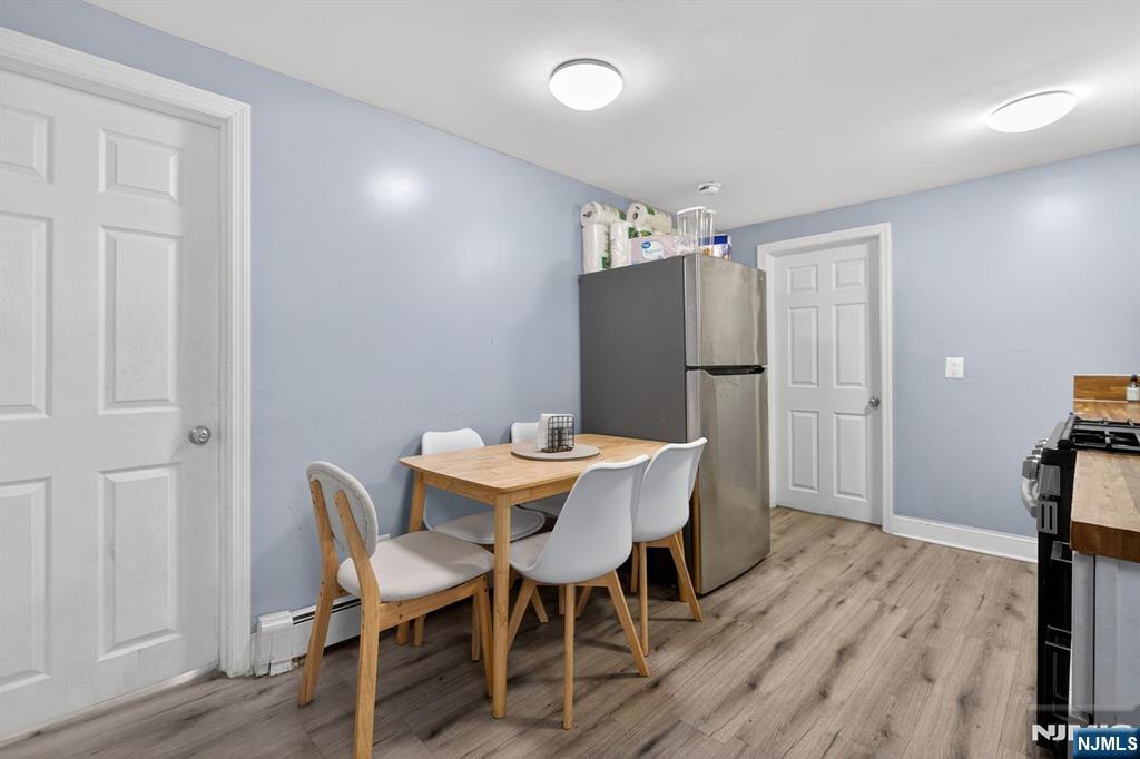229 Patterson Street Harrison, NJ 07029 - Photo 14 of 25 a view of a dining room with furniture and wooden floor