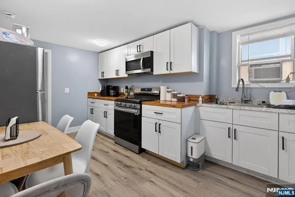 a kitchen with stainless steel appliances granite countertop a stove a sink dishwasher and a refrigerator