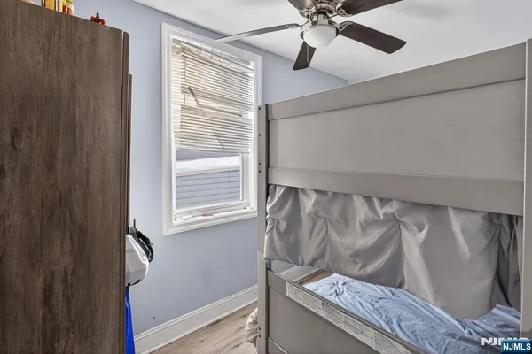 a view of a bedroom with a ceiling fan